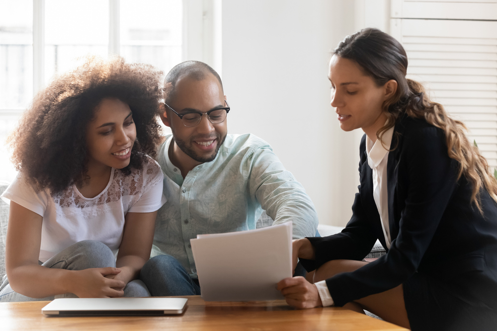 young couple with agent buying renters insurance in az