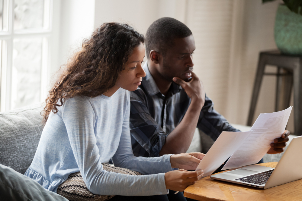 couple looking at renters insurance options on laptop