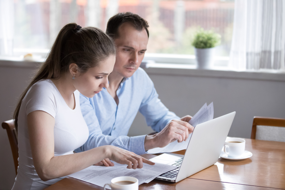 couple at home looking at laptop for renters insurance