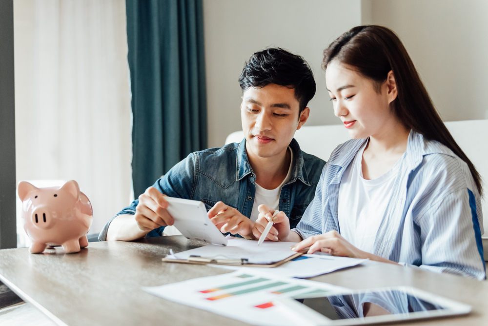young asian couple researching life insurance options