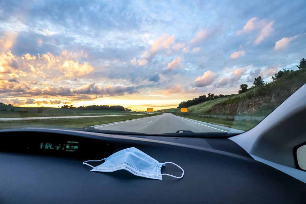 disposable mask on dashboard of card
