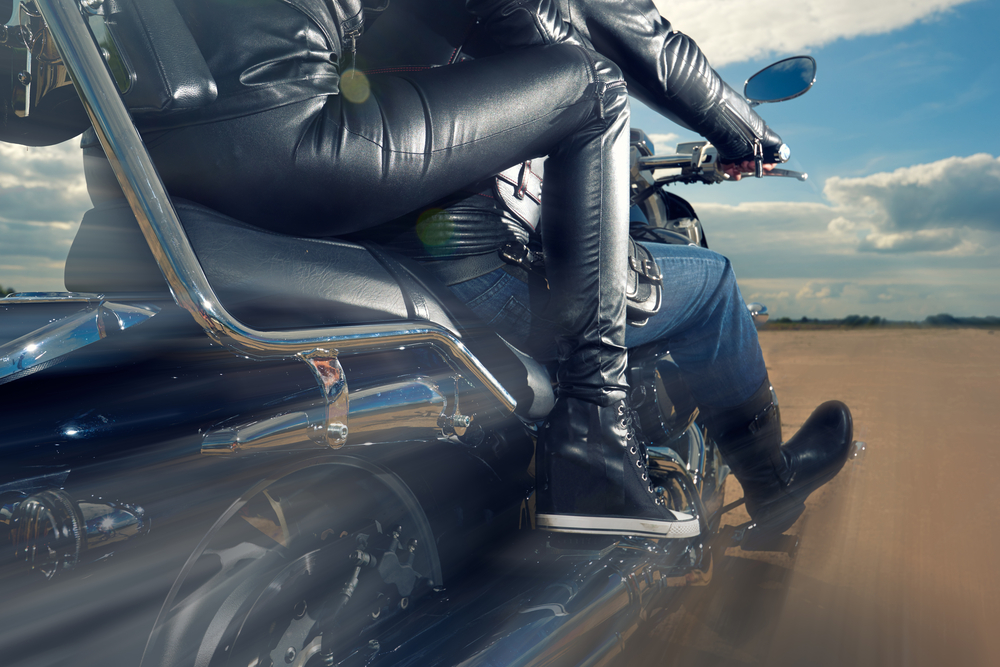 woman on the back of a motorcycle with another person