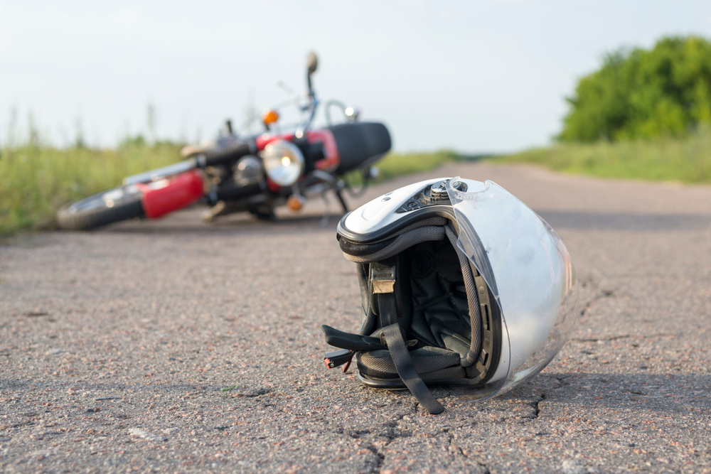 motorcycle helmet and bike crashed on road