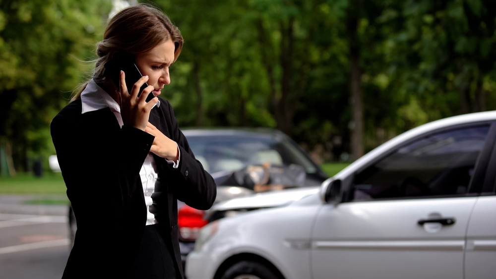 woman on the phone after getting in car accident