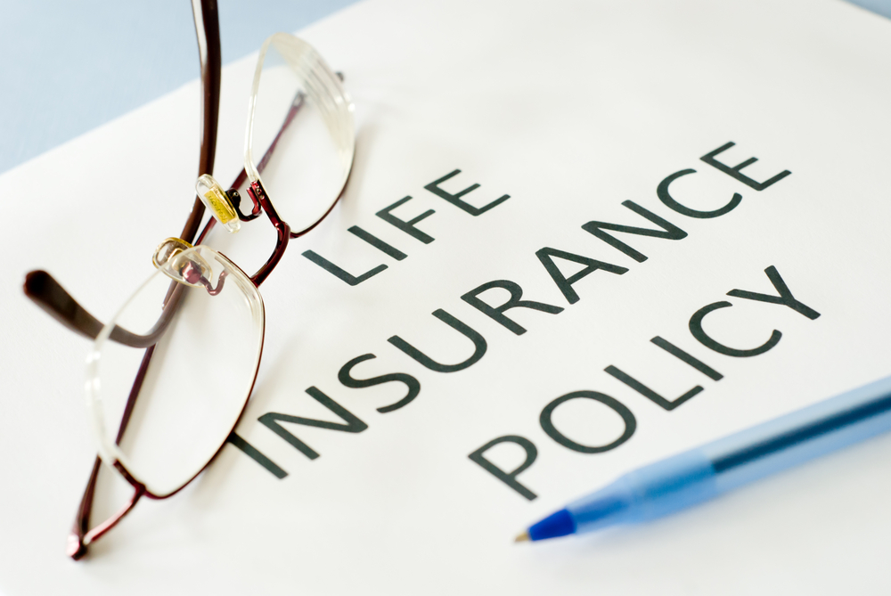life insurance policy document with glasses