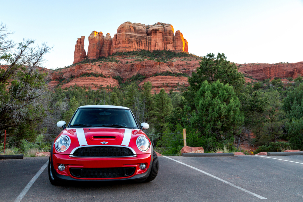 red car in front of arizona landscape