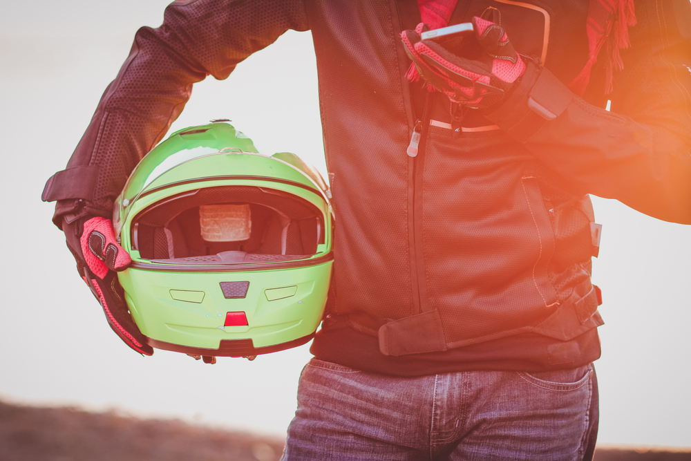 person holding motorcycle helmet