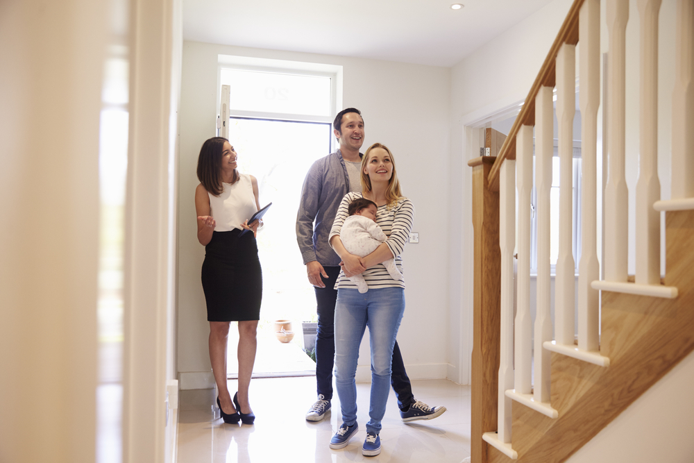 realtor and client looking at house