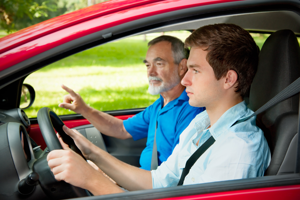 teen driver in car with father