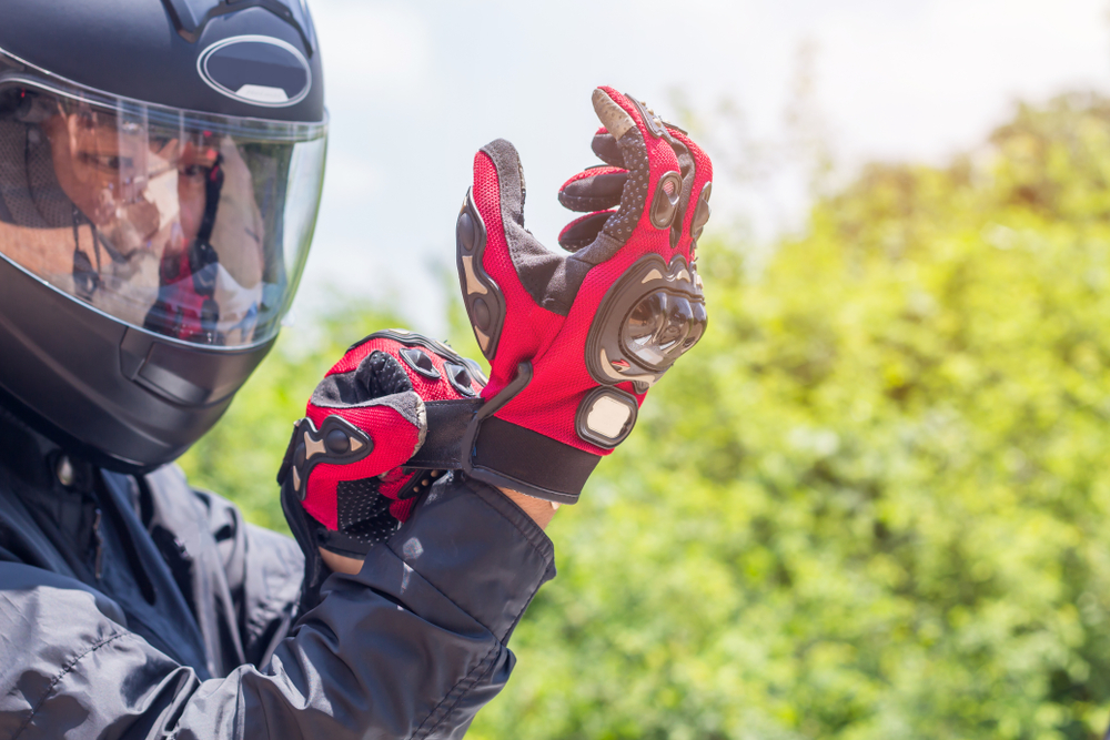man on motorcycle with helmet and gloves on