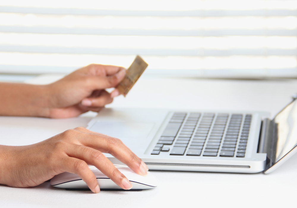 person at laptop with credit card