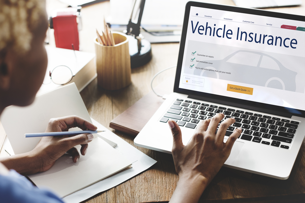 African American woman customizes her car insurance online